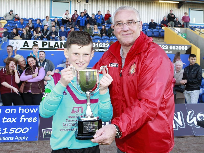 Chad Youth League Chairman Mick Kozluk presents Welbeck's George Smith-Grout the Knockout Trophy.