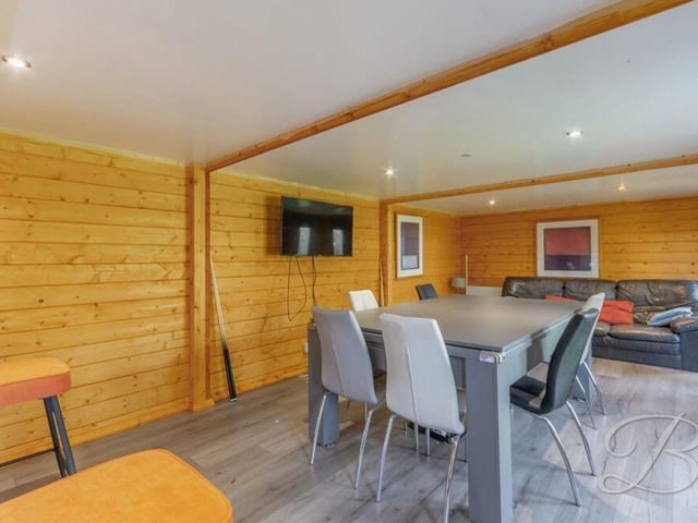 An appealing feature of the back garden is this summer house or cabin, which is great for social get-togethers.