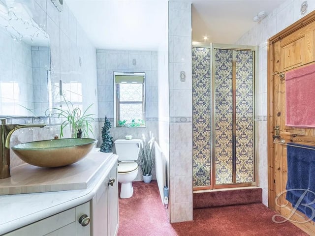 The bathroom is complete with a four piece suite including a bath, shower, low flush WC and hand wash basin.