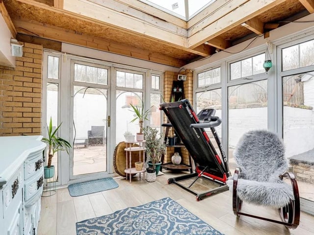 The conservatory has lvt flooring, a roof lantern and two sets of UPVC double French doors providing access out to the garden.