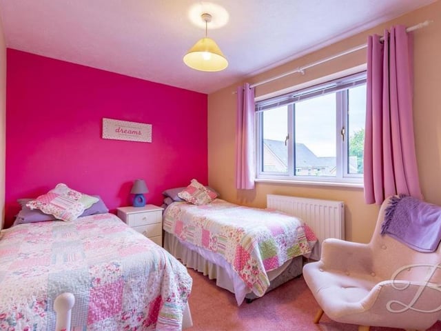 The third bedroom, which faces the back of the property, has space for two single beds. There is also a fitted wardrobe and carpeted floor.