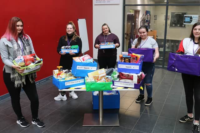 Tutor Kathryn Barker (centre) with some of her students and their hampers for The Beacon Project.