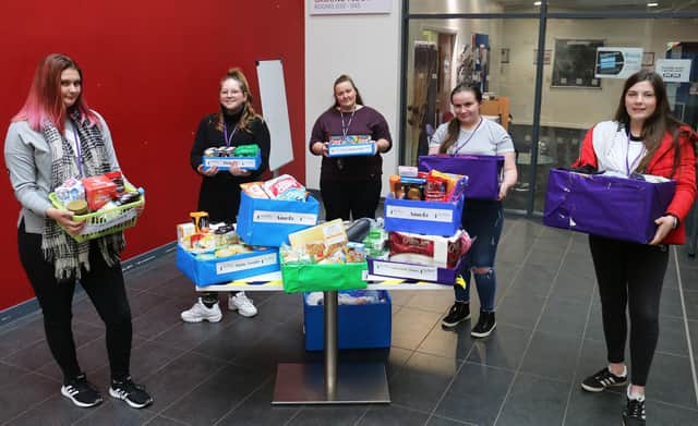 Tutor Kathryn Barker (centre) with some of her students and their hampers for The Beacon Project.