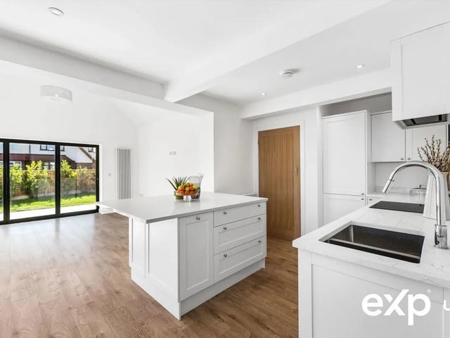 Every inch of this home has been thoughtfully rebuilt, reconfigured to create a light-filled, contemporary bungalow of exceptional quality. The heart of the home is the spectacular open-plan kitchen / dining / living room, measuring over 30ft. The bespoke white shaker kitchen is fitted with quartz worktops, chrome knobs, a large island with seating on two sides, larder cupboard and utility cupboard. Integrated appliances include a fridge freezer, slimline dishwasher, electric oven and induction hob with built-in extractor, plus a pull-out double bin, power for a instant hot water tap and an under-mounted 1.5 stainless sink with a chrome pull-out spray tap. There is a utility area just off of the kitchen area.