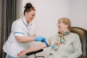 Healthcare Support Worker Lucy Walters preparing to take blood from a patient at Newark Hospital.