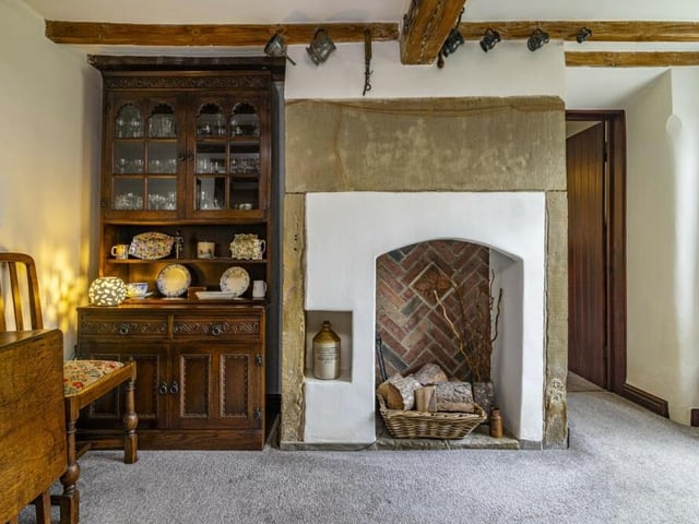 Here is a close-up of the original fireplace, which is such an eyecatching feature of the Jacksdale cottage's dining room.