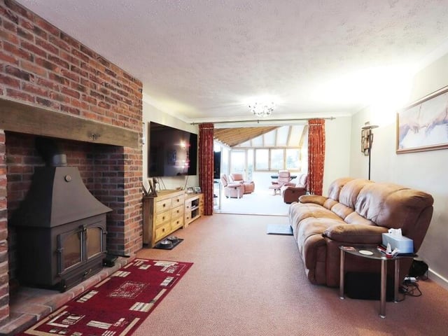 Next stop on our tour is this large living room or lounge. Its most distinctive feature is a multi-fuel log-burner.
