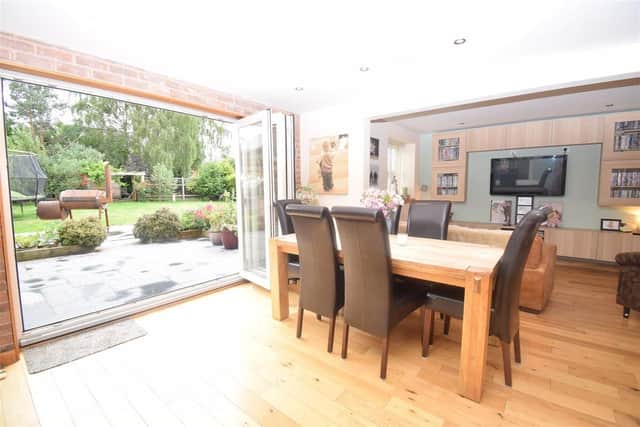 A family room has bi-fold doors onto the garden.