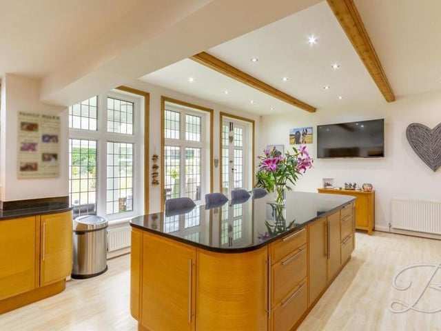 Nowhere in the house is the sense of space and style better exemplified than in the kitchen. It is bright thanks to downlights, under-cabinet strip lighting and double windows looking into the conservatory. Ceiling beams add to its character.