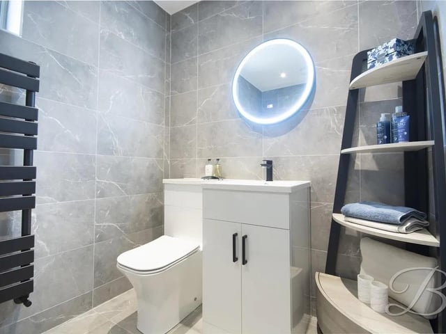 The contemporary family bathroom accessed from the main hallway