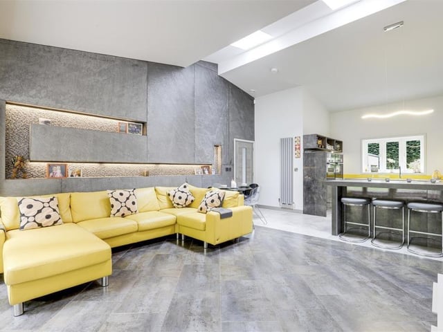 The stylish open-plan living at the Newstead Abbey Park bungalow means that the large lounge and modern breakfast kitchen are joined at the hip. The lounge, or living room, has tiled flooring with underfloor heating, two vertical radiators, two skylight windows, a fitted Gwinner Media storage unit, a feature wall with LED lighting and recessed spotlights.