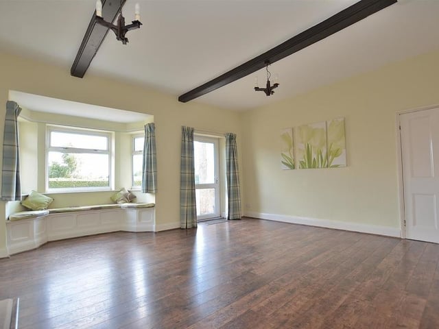 There are even seats in the large, double-glazed bay window, which lets in plenty of natural light to the dining room. Also, there is access to a second staircase to the first floor.