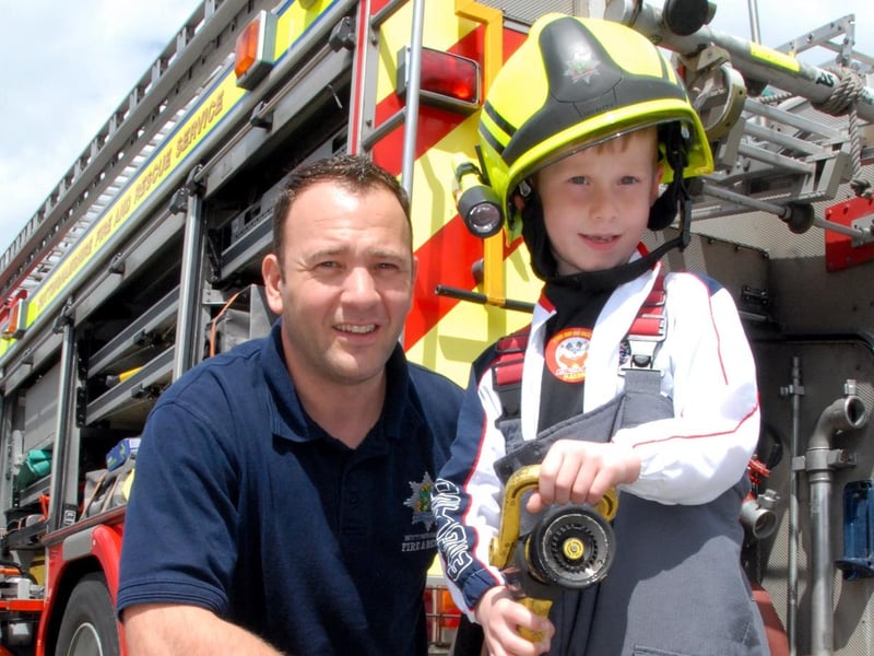 Sutton's St Mary Magdalene Primary School held a summer fair. Pupil, 6-year-old Braydon Warren became a firefighter for the day. Braydon is pictured with Ashfield Red Watch, firefighter, Peter White.