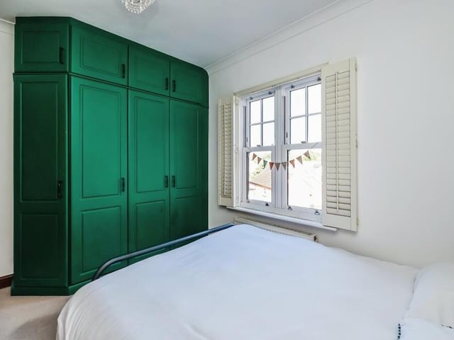 The third bedroom features built-in storage, courtesy of these impressive wardrobes.