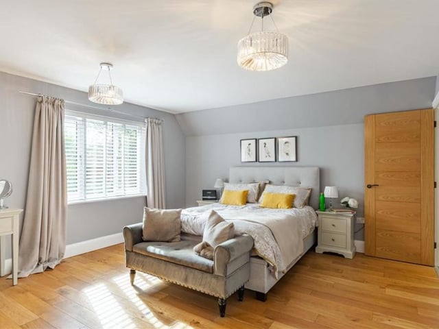 Upstairs, an impressive, galleried landing leads to the four bedrooms, including this master, with its oak floor and window overlooking the back garden. As well as an en suite bathroom, it has a dressing room with two separate sets of fitted wardrobes.