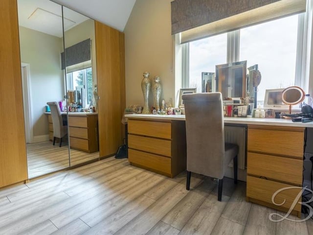 An area for a dressing table and fitted wardrobes that forms part of the main bedroom.