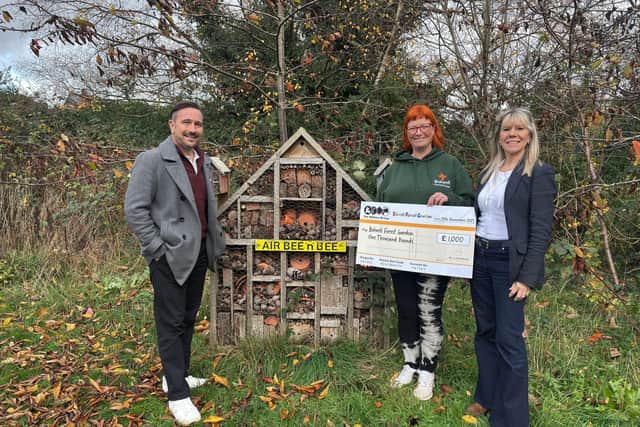 The team at the Wilkins Group handing the cheque to Barbara Bates, operational manager and Forest School practitioner (centre)