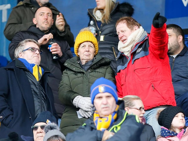 Mansfield Town fans watch the match against Northampton Town.