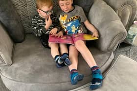 Big brother Logan, reading to little brother Olly. Photo: Sharon Hartshorn