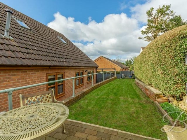 A look down the lawn from the patio area. As you can see, the rear garden is private and enclosed by hedges.