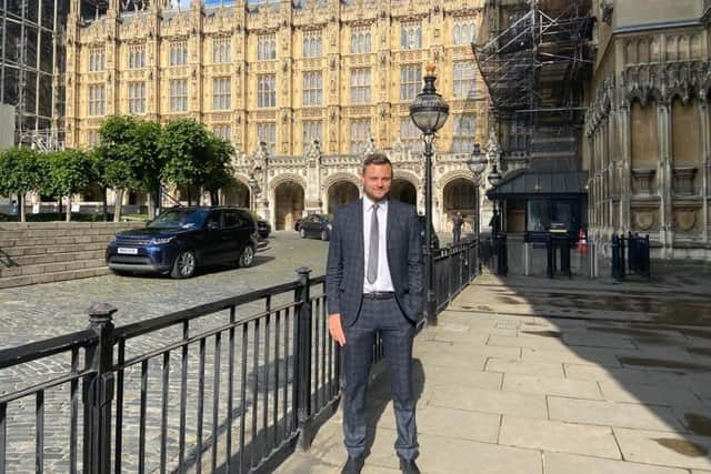 Coun Ben Bradley outside Parliament in Westminster.