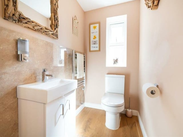 Stylish, modern decor is apparent throughout the house -- even in the downstairs toilet, which has a WC, heated towel-rail and wash hand basin with storage beneath.