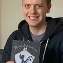 Scott holding his first copy of his book
