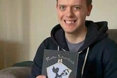 Scott holding his first copy of his book