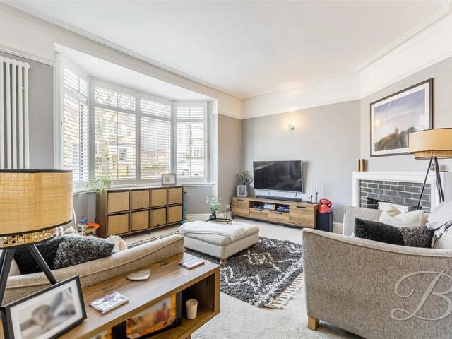 The ground floor welcomes you with a spacious living room, featuring a large bay window that floods the room with natural light.