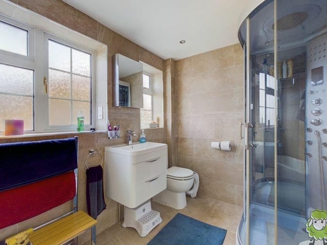 Most of the bedrooms are served by this family bathroom, which features a spa shower.