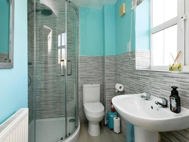 The master bedroom benefits from this en suite shower room. It comprises an enclosed shower cubicle, wash hand basin and low-flush WC