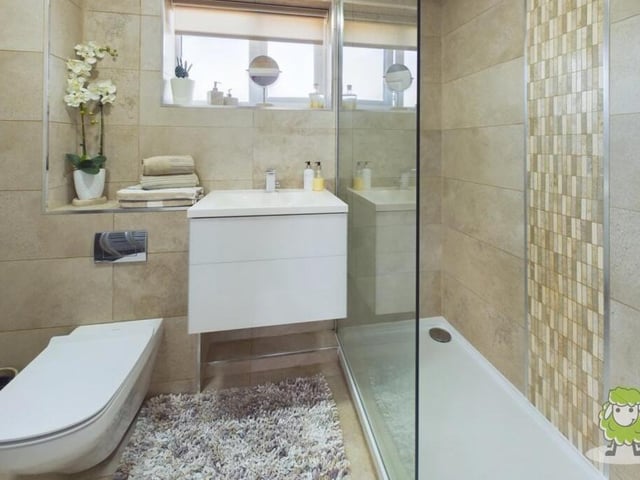 Completing our tour of the first floor is this family bathroom, which is fully tiled and boasts a spacious walk-in shower enclosure.