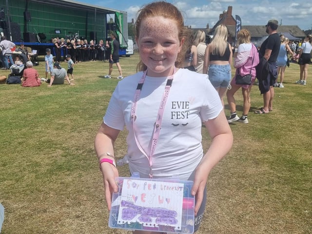 Lexi-May selling loombands, with an EvieFest t-shirt on.