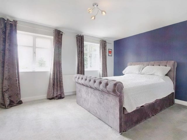 Our first-floor tour begins in the master bedroom, which is a large, light room with built-in storage in the form of fitted wardrobes,, carpeted flooring and an en suite. It overlooks the front of the house.