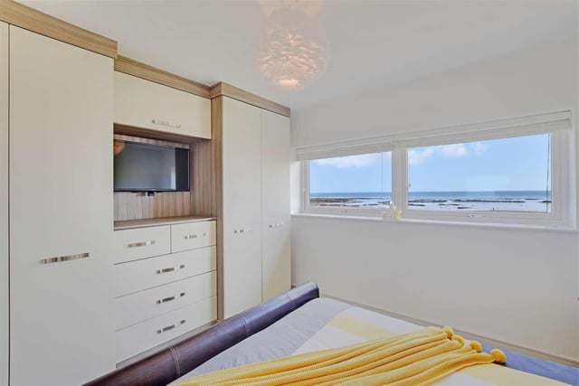 Another well-sized bedroom which includes fitted wardrobes and offers sea views.