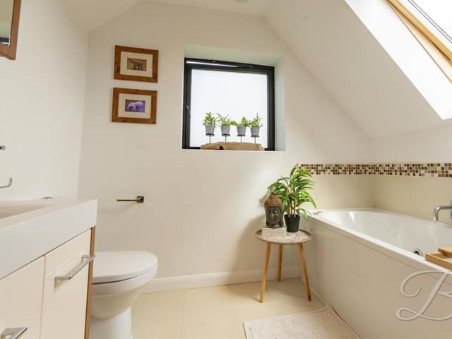 Another of the bathrooms at the four-bedroom Forest Town house. A bonny space, it features bath, wash hand basin and low-flush WC.