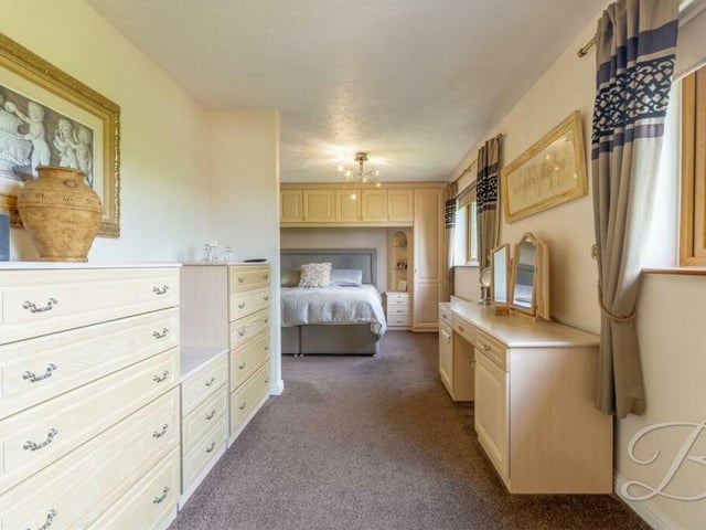Into the master bedroom which, as you can see, has storage space aplenty. Two windows overlook the back garden.