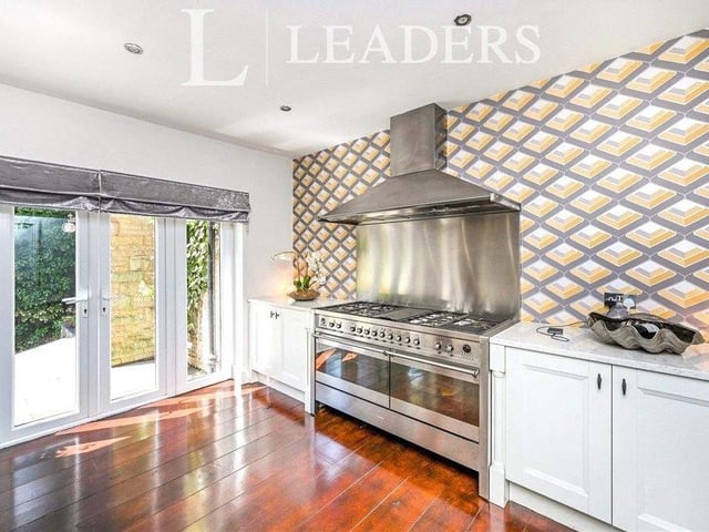 The kitchen also boasts beautiful views across the woodland grounds of the property. Other features include a Smeg dual fuel range cooker, with stainless steel splashback and chimney hood over, ceiling spotlights and oak flooring.