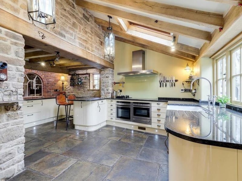 Next stop is the fitted breakfast kitchen, which is an absolute stunner. Flagstone flooring with underfloor heating, exposed oak ceiling beams, two Velux windows and a double-glazed window overlooking the back garden are just some of its assets.