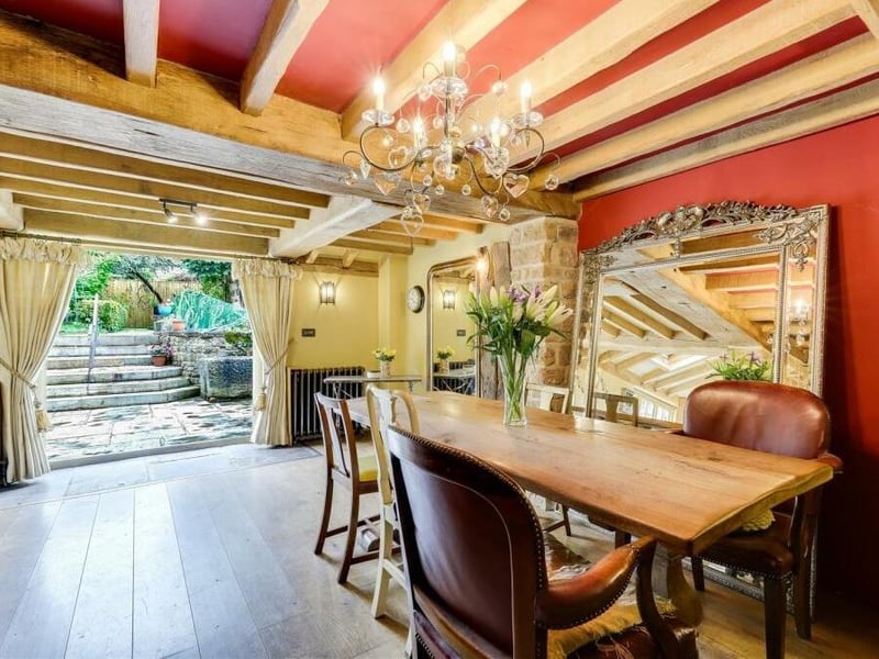 More ceiling beams abound in the dining room, which also has a solid-oak floor, exposed brick walls and two cast-iron radiators. But its main assets are double French doors that open out to the rear garden.