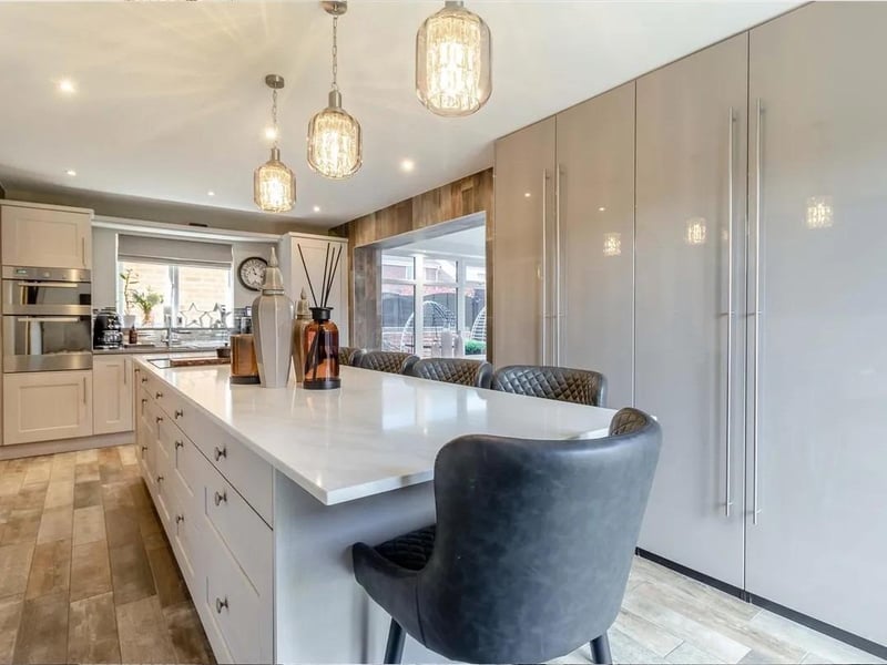 There is a substantial central island which can accommodate seating for 6 people and French doors to the rear.