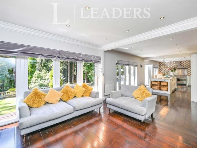 Opening out from the kitchen is this pleasant and sunny sitting area that has large, bright windows and also French doors leading outside. Oak flooring, spotlights and decorative coving add to its appearance.