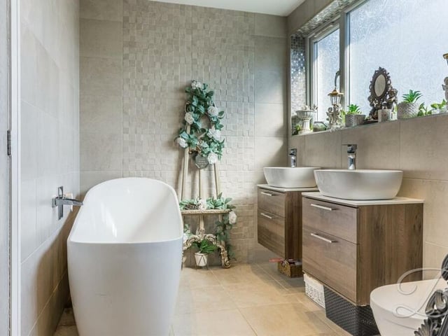 We complete our tour of the interior of the property in the impressive family bathroom, which consists of a free-standing bath, double wash hand basins with vanity storage, chrome, heated towel-rail, floor and wall tiling and downlights.