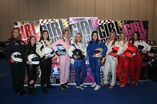 Karen Andrews, left, and other female racing drivers on on the GirlRacer stand at the Motorsports Show at London's Excel Centre.