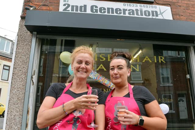 Owner Dallas Seamer and faithful staff member Kelly Moore celebrate the 30th birthday of the 2nd Generation hair salon in Mansfield.
