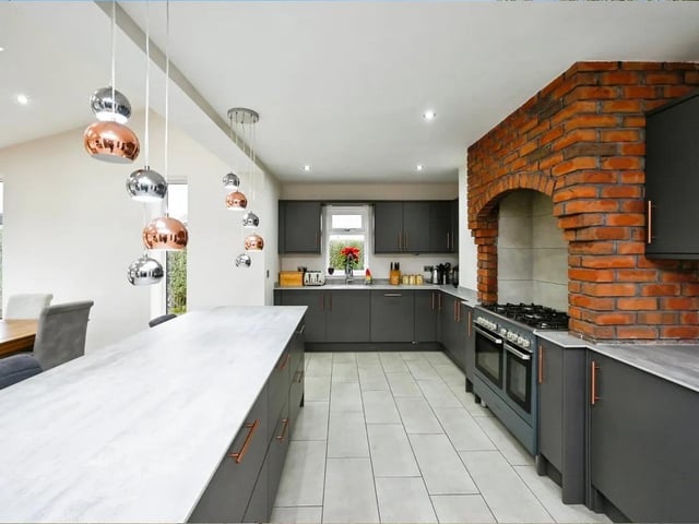 The stylish open-plan kitchen boasts a kitchen island