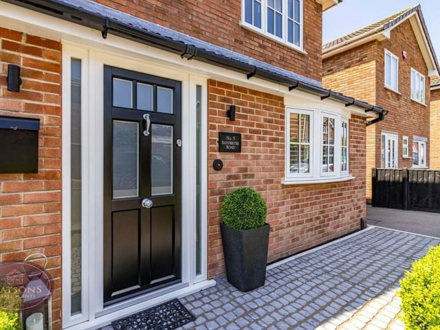 Let's return to the front for our final photo, which shows the welcoming entrance and a tarmacadam driveway, which offers plenty of off-street parking space and leads to a car port. There is also an electric-car charging point and an external tap.