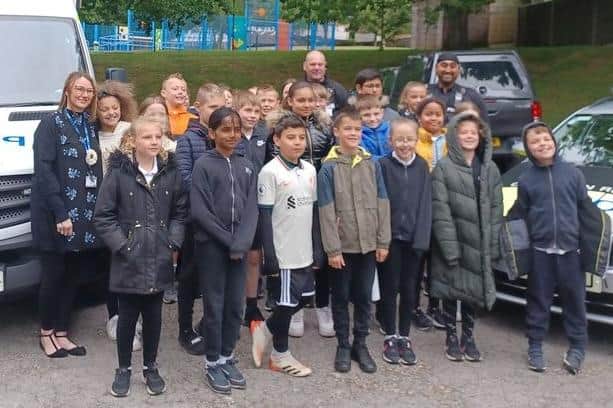 Schoolchildren and staff with members of the Operation Reacher team.