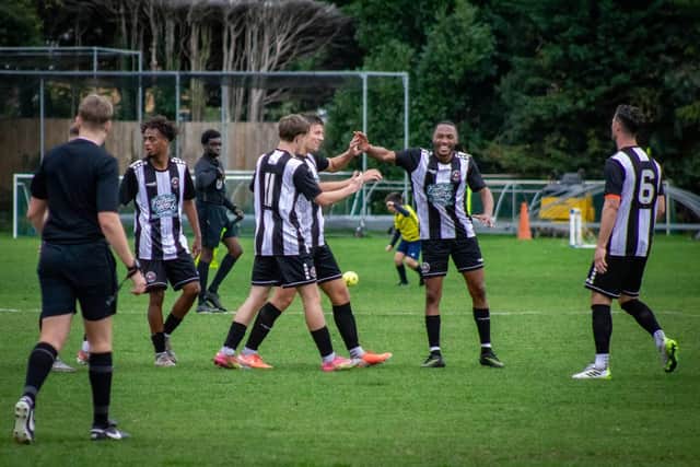 Eastwood celebrate scoring at Irchester on Saturday. Photo by Scott Messom.
