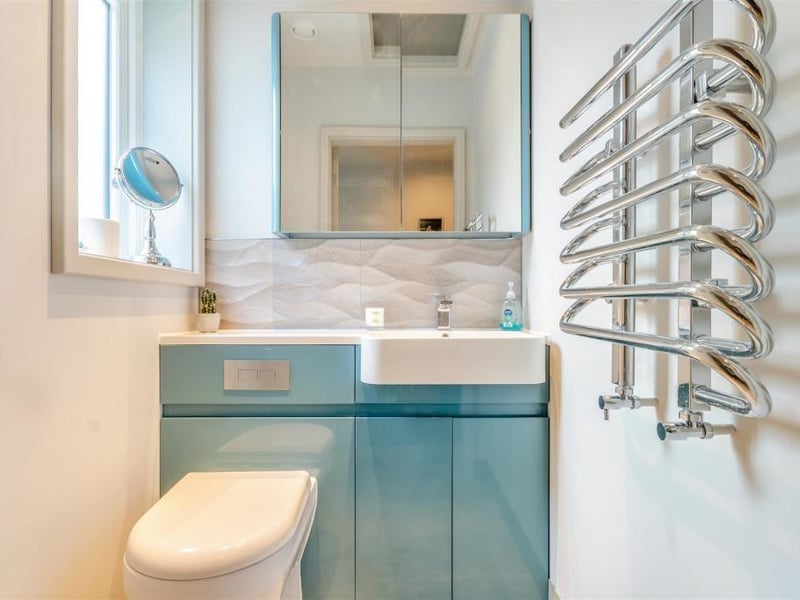 Like all rooms at the bungalow, even the toilet is well presented and squeaky-clean. A two-piece white suite comprises a dual-flush WC with enclosed cistern, and a vanity unit with inset wash hand basin, chrome mixer tap, work surface to the side and storage cupboard underneath. There's also a chrome, heated towel-rail, two ceiling spotlights, tiled floor and a loft hatch.